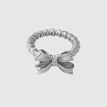 Flat lay of GRISÉ NYC Croquette bow stainless steel ring.
