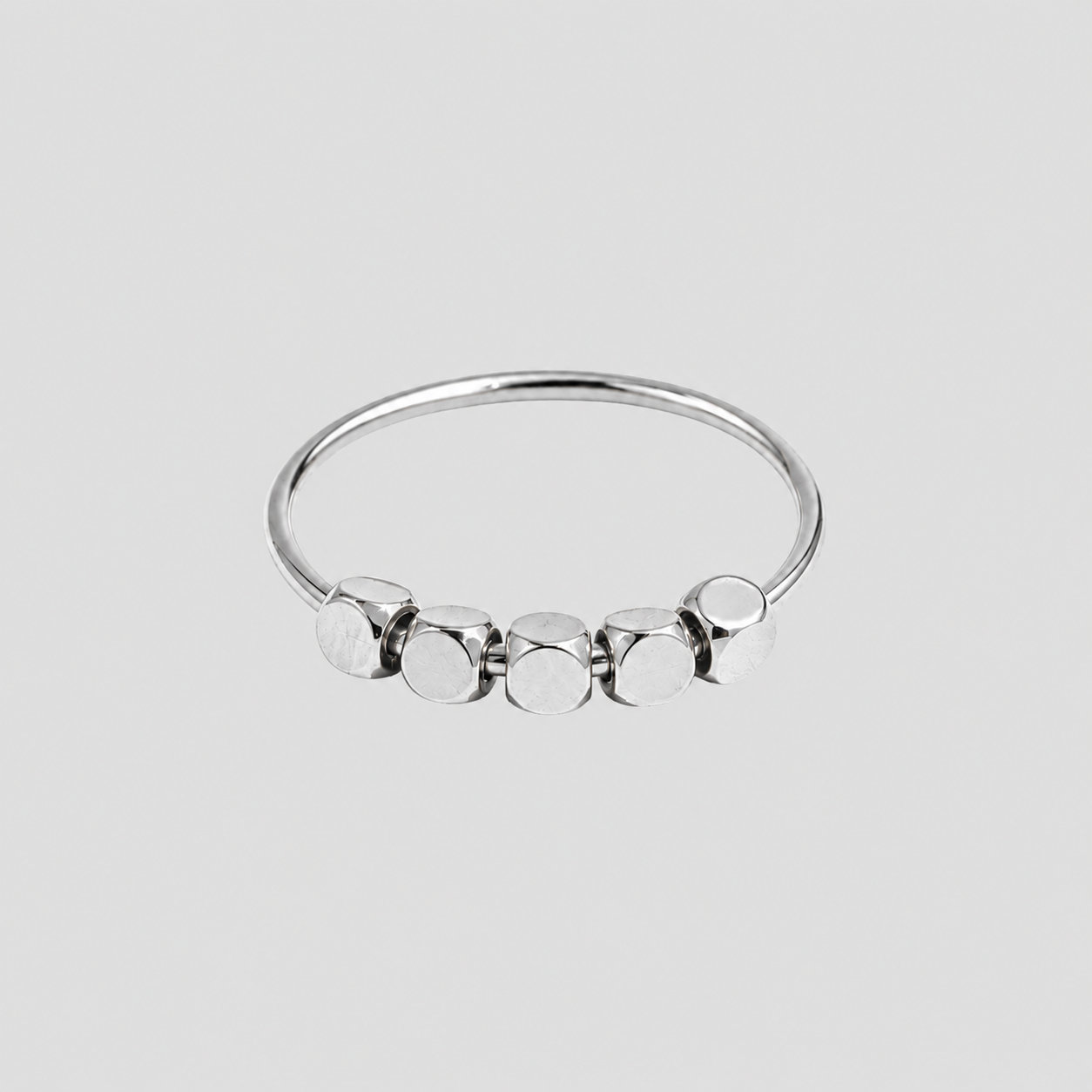 Dainty Bead Ring in polished stainless steel featuring five geometric bead accents on a minimalist silver band by GRISÉ NYC.