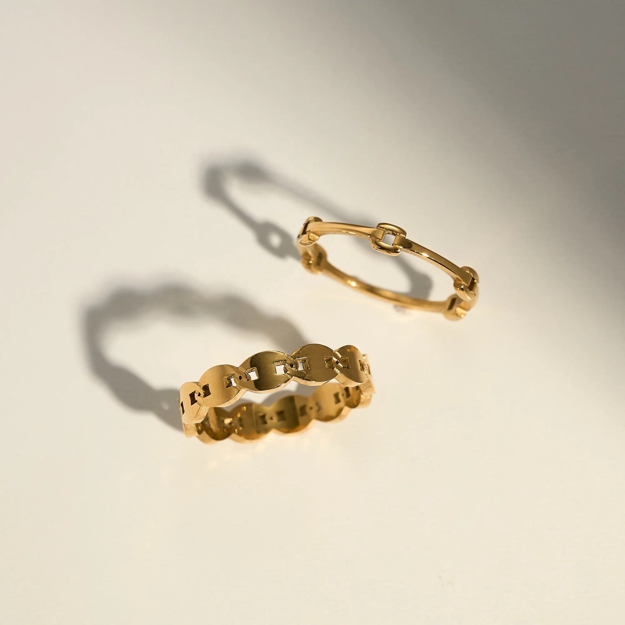 GRISÉ NYC Dainty Minimal Link 18k Gold Ring displayed with coordinating gold rings, showcasing a minimalist stackable jewelry collection.