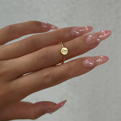 GRISÉ NYC Dainty Ying Yang 18k Gold Ring worn on middle finger.