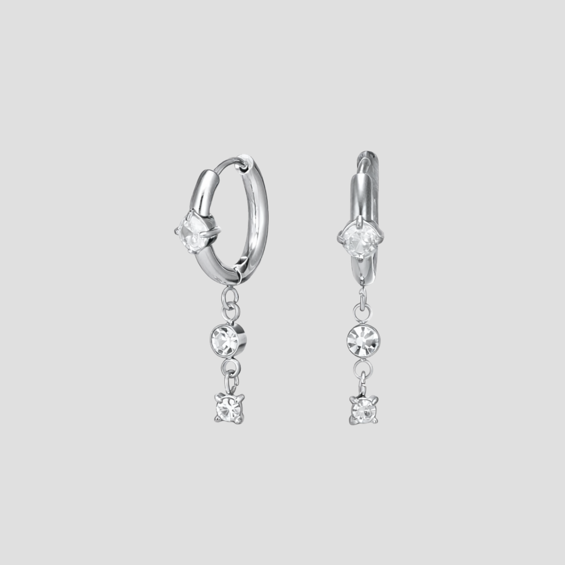 GRISÉ NYC silver dangle gemstone hoop earrings in stainless steel with cubic zirconia stones.