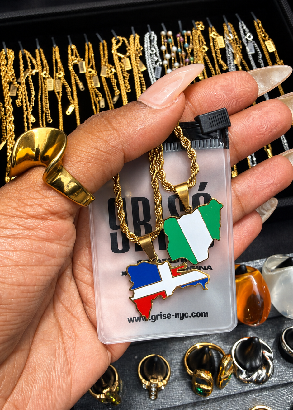 GRISÉ NYC Dominican Republic enamel pendant necklace gold shown in hand lifestyle shot.