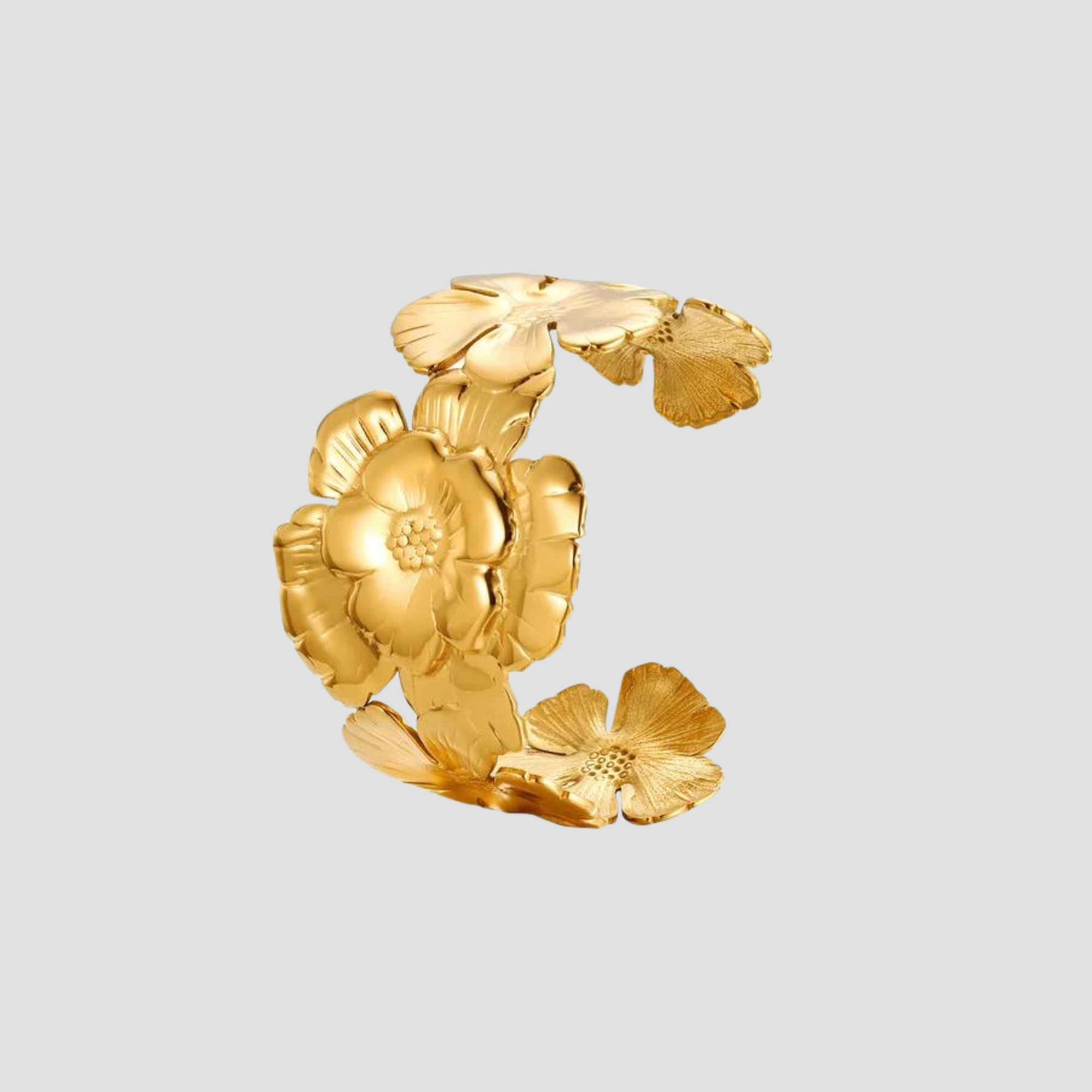 Flat lay of GRISÉ NYC embossed flower 18k gold plated cuff bracelet
