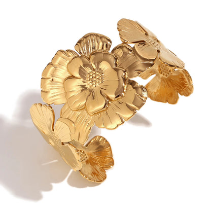 GRISÉ NYC embossed flower 18k gold plated cuff bracelet close up. 