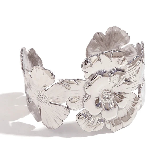GRISÉ NYC embossed flower silver cuff bracelet on white background.
