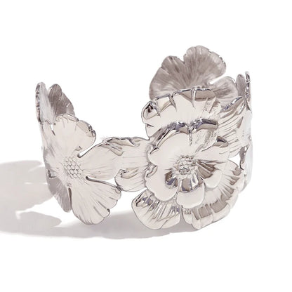 GRISÉ NYC embossed flower silver cuff bracelet on white background.