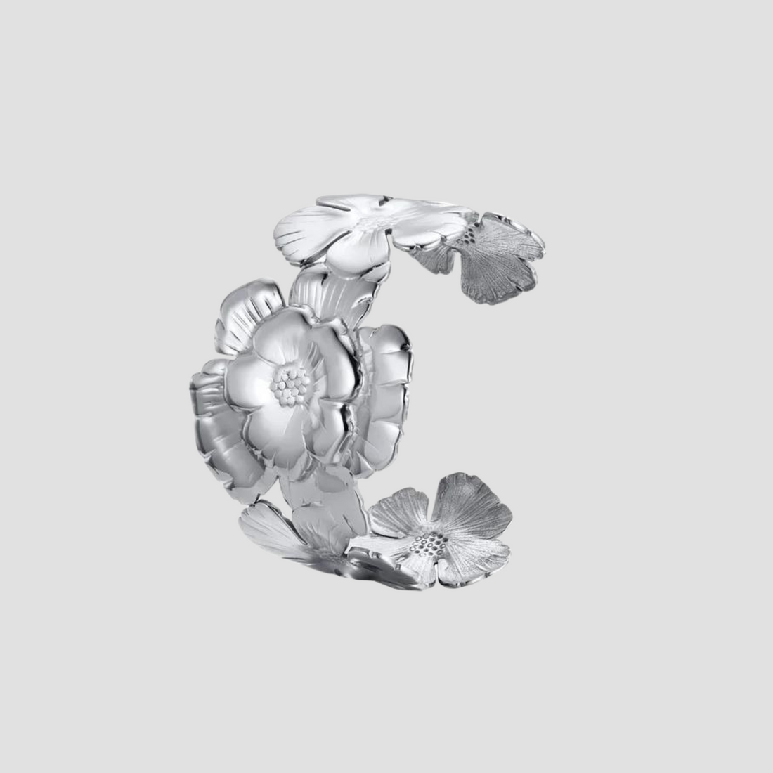 Flat lay of GRISÉ NYC embossed flower stainless steel cuff bracelet
