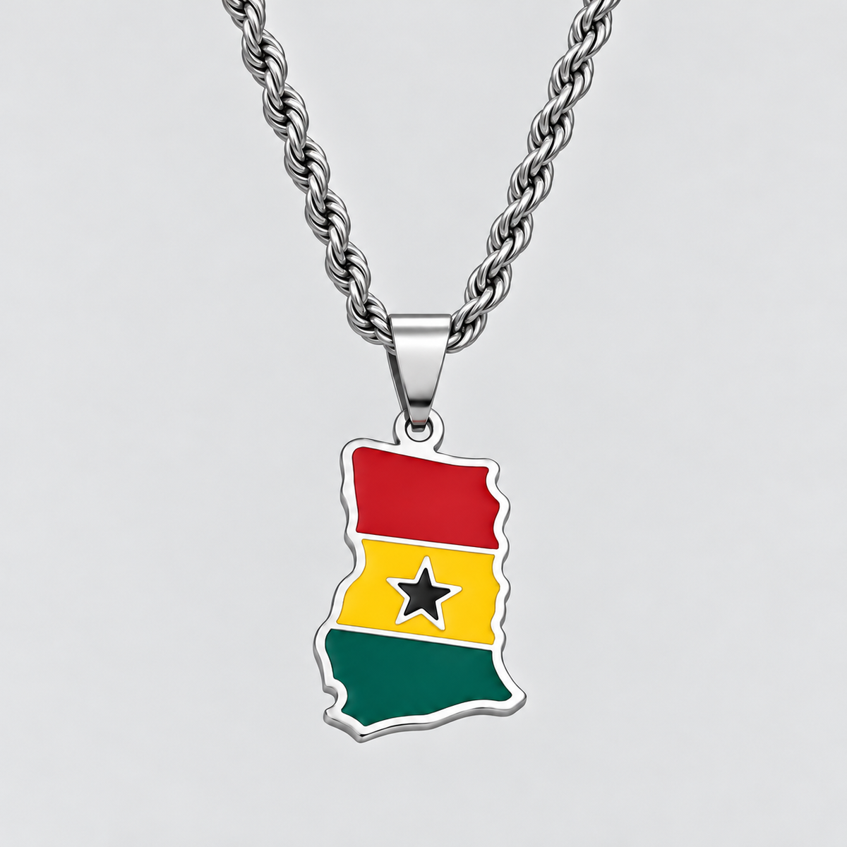 GRISÉ NYC silver Ghana flag map pendant necklace featuring red, yellow, and green enamel with a black star, paired with a 3mm silver rope chain on a light grey background.