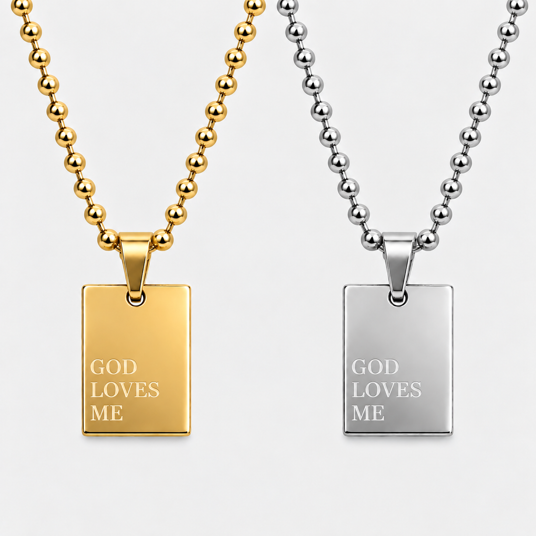 GOD LOVES ME pendant necklace by GRISÉ NYC shown in gold and silver colorways.