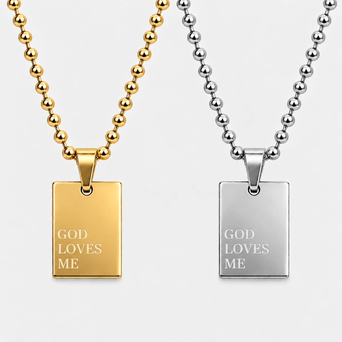 GOD LOVES ME pendant necklace by GRISÉ NYC shown in gold and silver colorways.