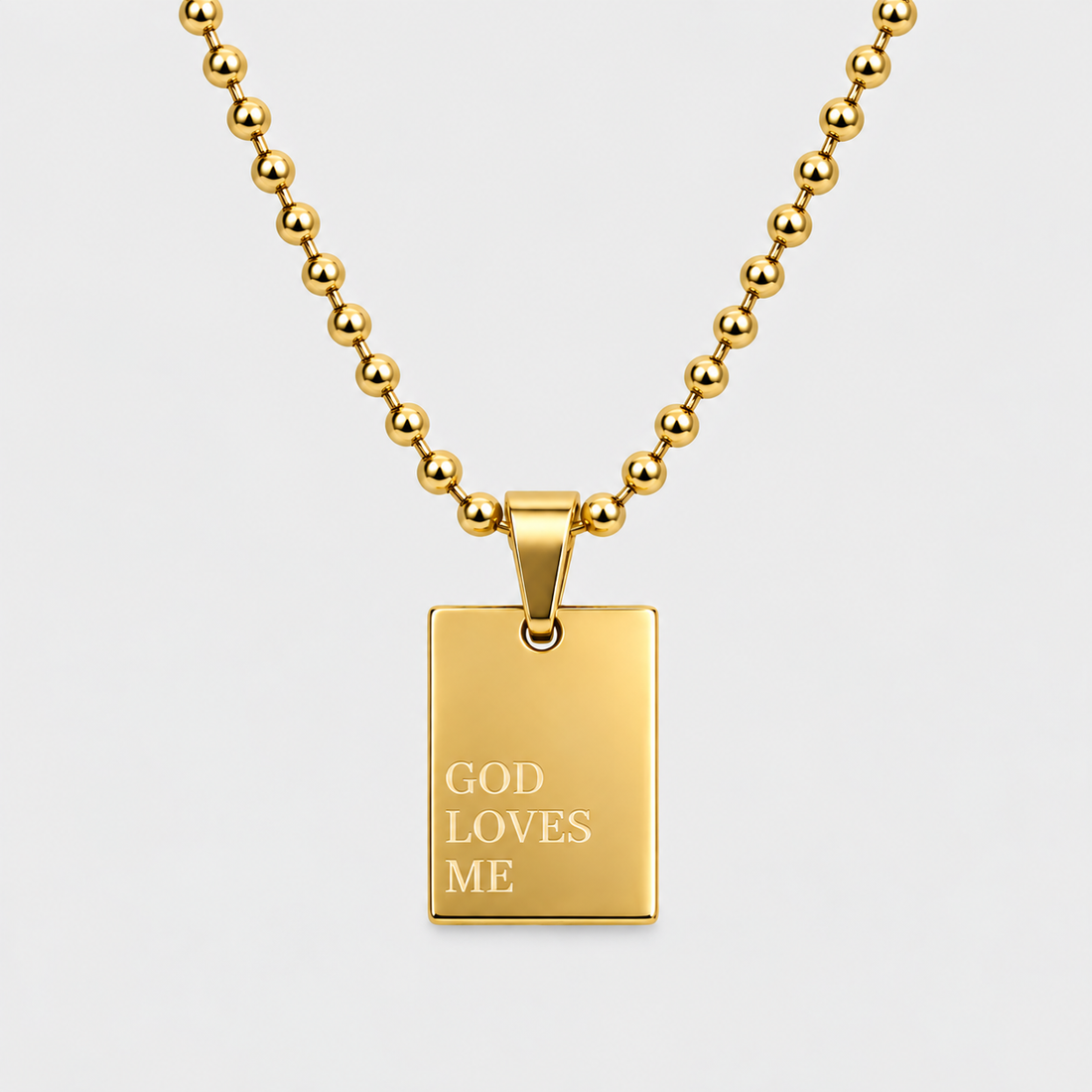 GOD LOVES ME engraved pendant necklace in 18K gold-plated stainless steel by GRISÉ NYC.