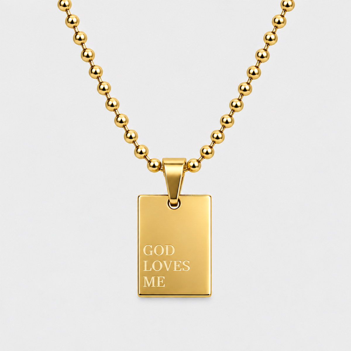 GOD LOVES ME engraved pendant necklace in 18K gold-plated stainless steel by GRISÉ NYC.