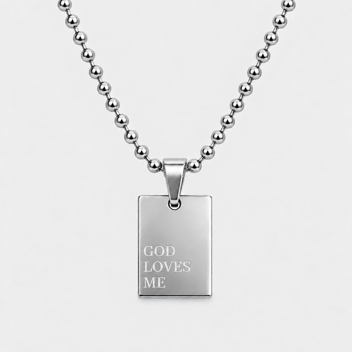 GOD LOVES ME engraved pendant necklace in silver stainless steel by GRISÉ NYC.