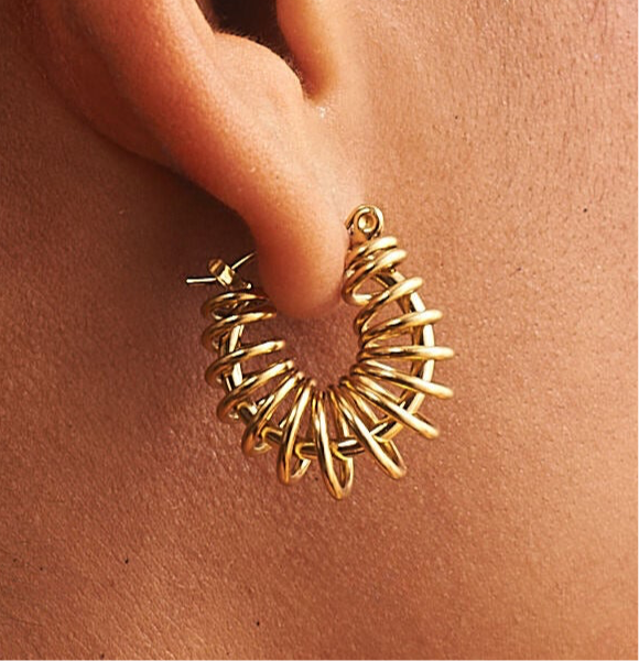 Close up of gold barbed wire hoop earrings highlighting textured design by GRISÉ NYC 