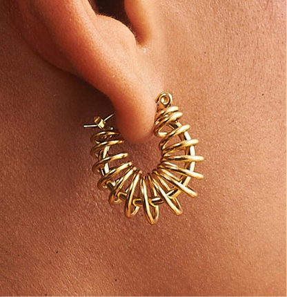 Close up of gold barbed wire hoop earrings highlighting textured design by GRISÉ NYC 