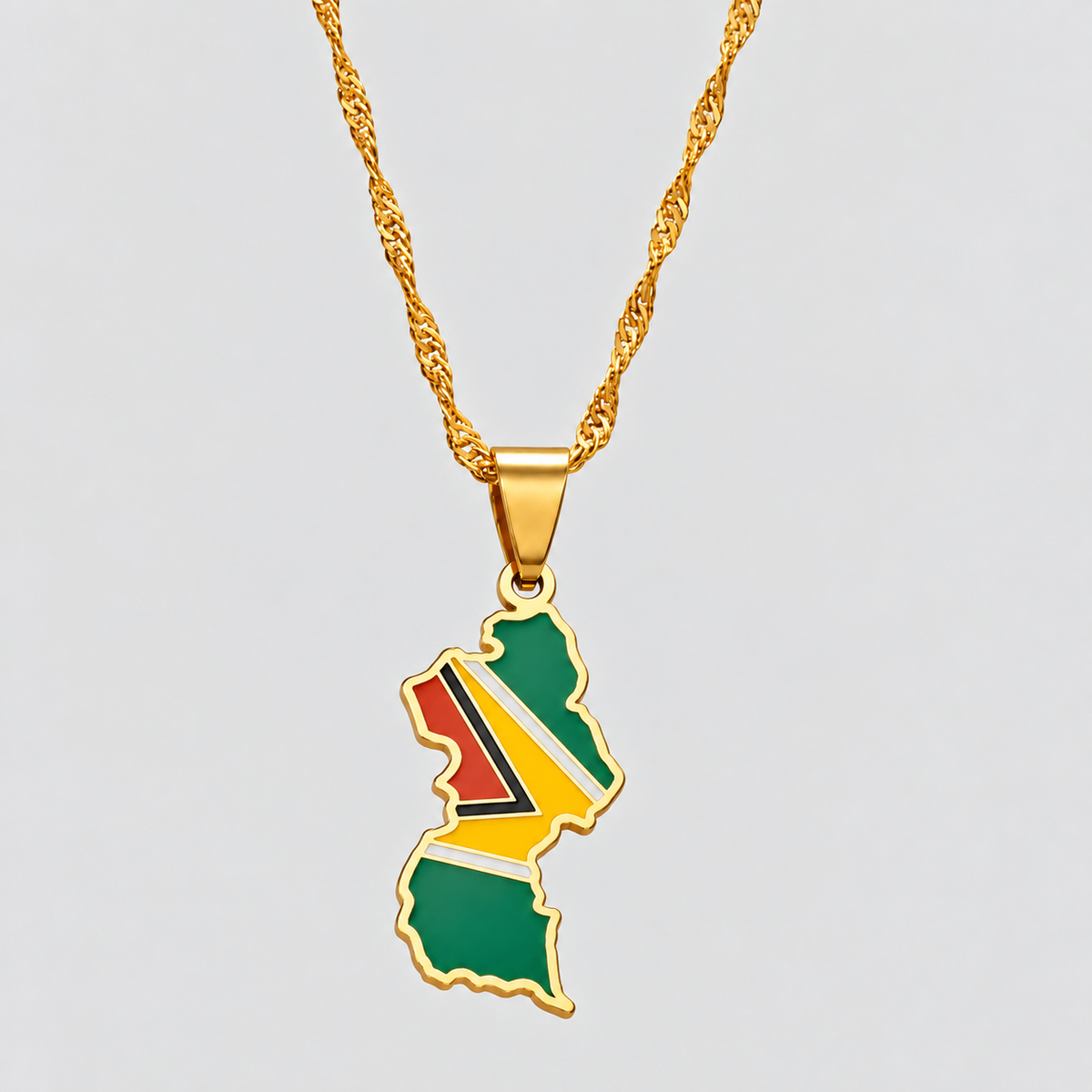 GRISÉ NYC gold Guyana flag map pendant necklace featuring green, red, yellow, black, and white enamel detailing with a matching gold-tone chain.