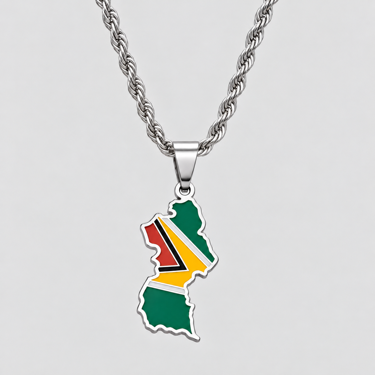 GRISÉ NYC silver Guyana flag map pendant necklace featuring green, red, yellow, black, and white enamel detailing on a 3mm silver rope chain.