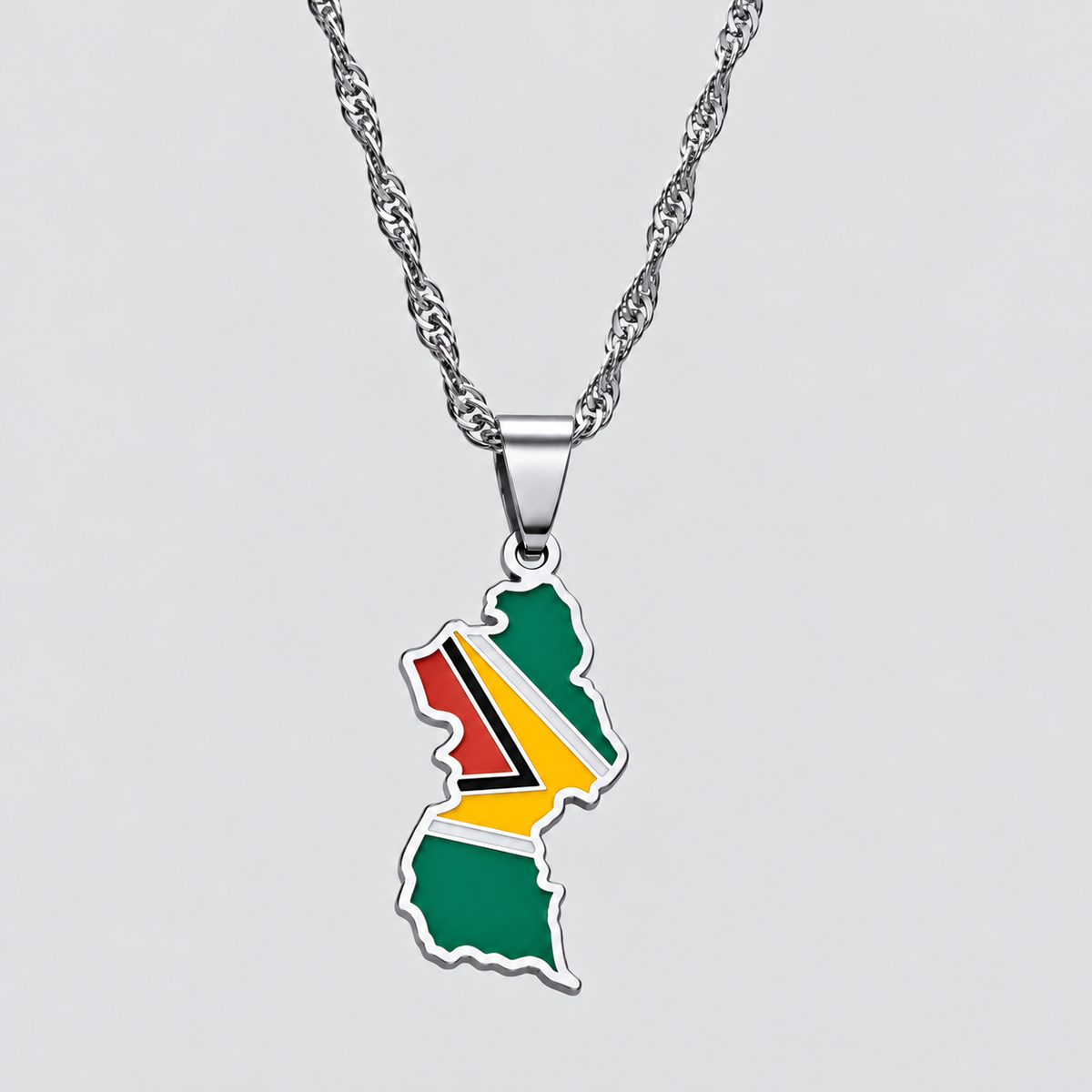 GRISÉ NYC silver Guyana flag map pendant necklace featuring green, red, yellow, black, and white enamel detailing with a matching silver-tone chain.