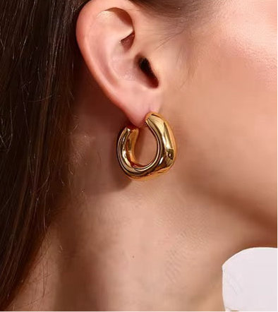 GRISÉ NYC irregular gold midi earrings styled on ear for minimalist bold look.