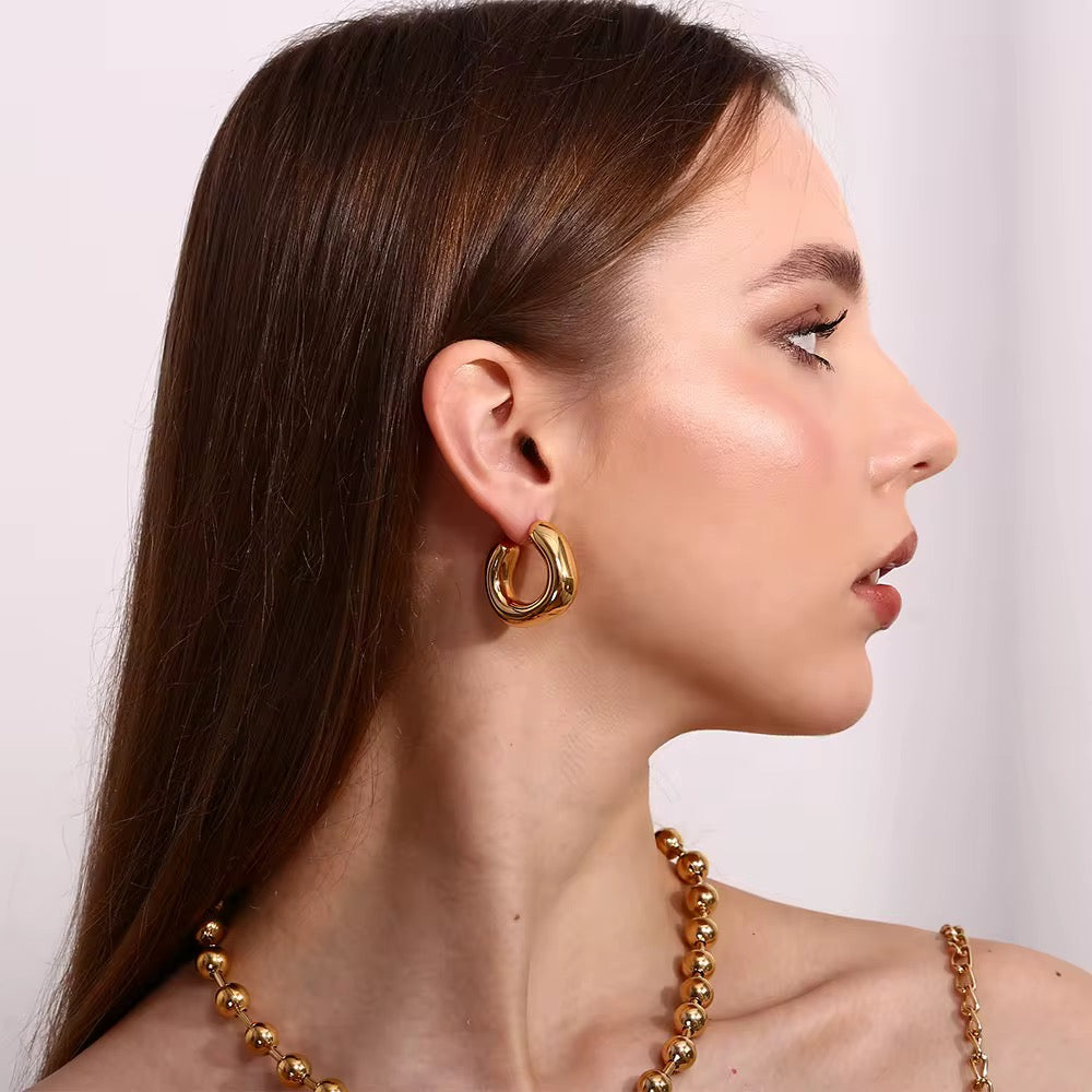 gGRISÉ NYC Irregular Bold Midi Gold Earrings shown in side profile with sleek hairstyle.
