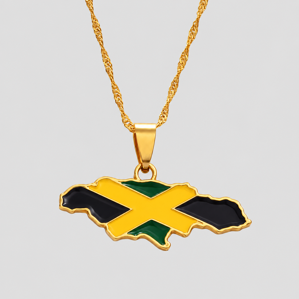 Gold Jamaica map pendant necklace by GRISÉ NYC featuring the Jamaican flag in black, green, and gold enamel on a textured gold-tone chain.