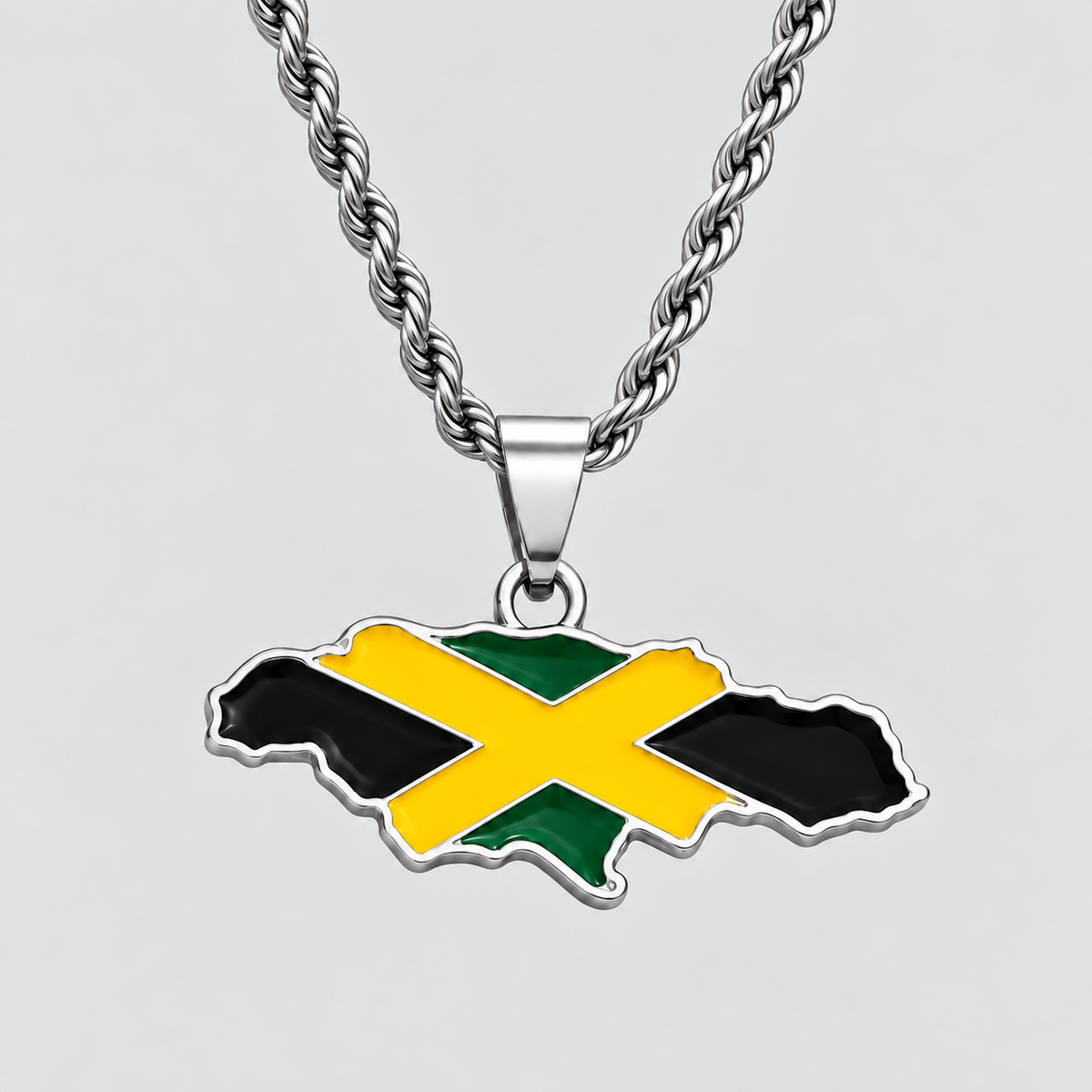 GRISÉ NYC silver Jamaica flag map pendant necklace featuring black, green, and yellow enamel detailing, paired with a 3mm silver rope chain on a light grey background.
