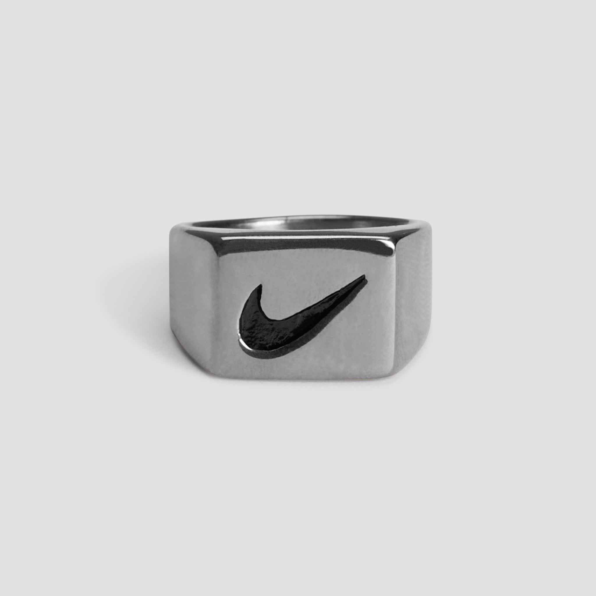 Just Do It stainless steel ring featuring a polished silver finish and swoosh-inspired design.