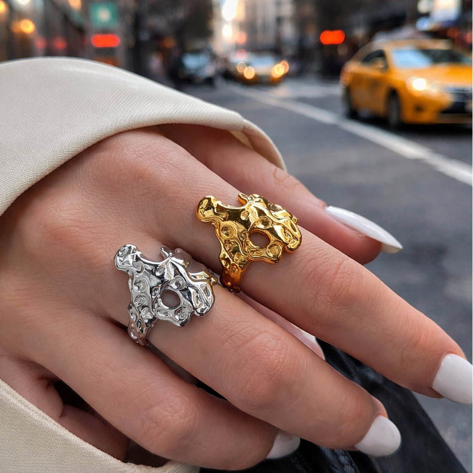 GRISÉ NYC liquid gold and silver rings worn on hand in city street setting with sculptural molten design