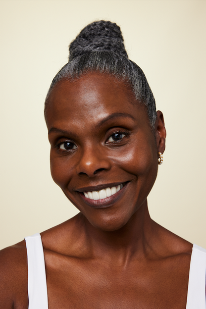 Model wearing mini midi pearl hoop earrings in gold plated stainless steel by GRISÉ NYC.