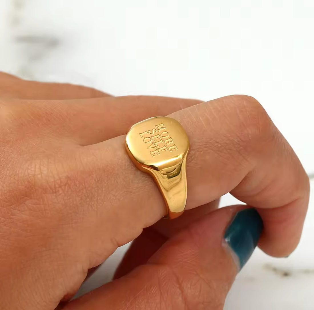 MORE SELF LOVE gold signet ring worn on hand