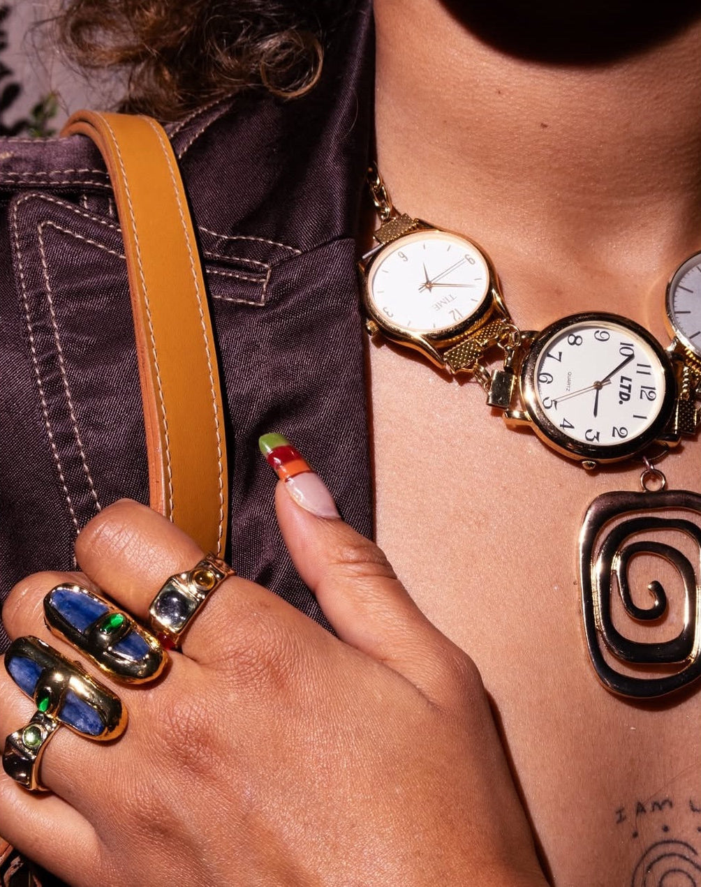 Model wearing the GRISÉ NYC Mundo Azul Baroque Double Pill Ring in gold with blue stone details styled in stacked jewelry.