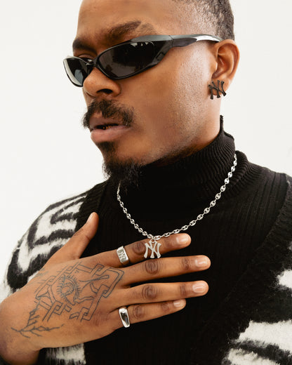 Male model wearing New York Yankees stainless steel mariner chain necklace in silver by GRISÉ NYC, bold statement pendant.