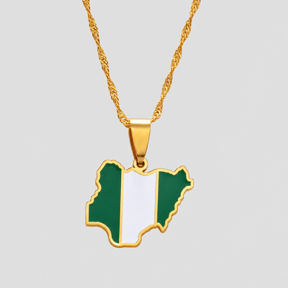 Gold Nigeria flag map pendant necklace by GRISÉ NYC featuring green and white enamel detailing, polished gold-tone edges, and a textured gold chain on a light gray background.