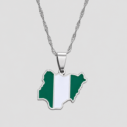 Silver Nigeria flag map pendant necklace by GRISÉ NYC featuring green and white enamel detailing, polished silver-tone edges, and a textured silver chain against a light gray background.