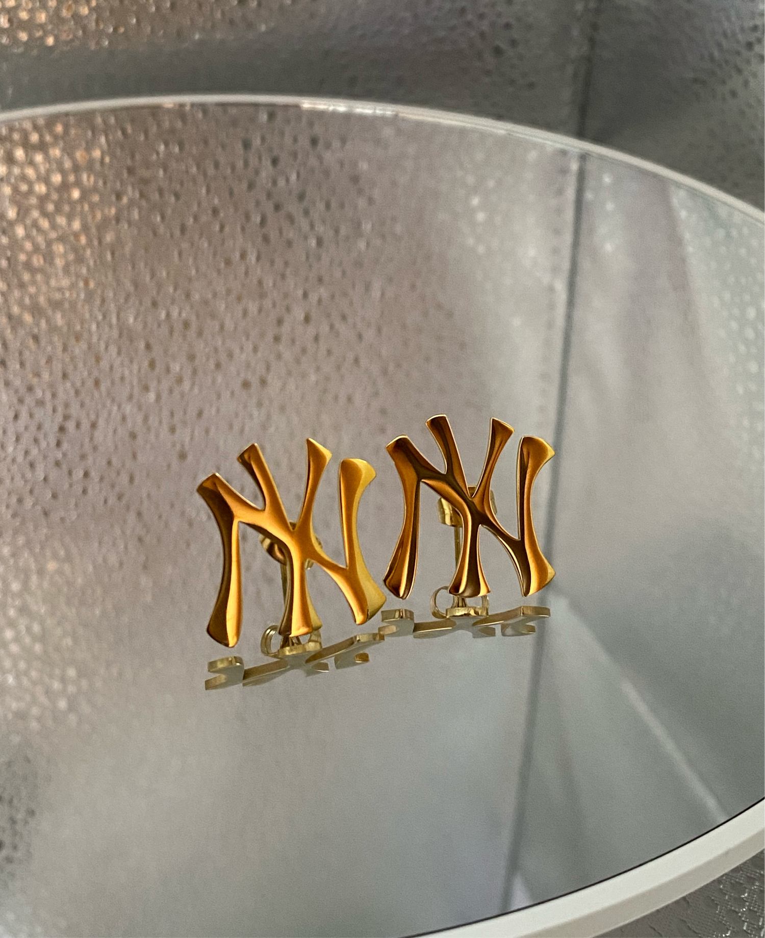 GRISÉ NYC NY logo gold stud earrings in 18k gold plated stainless steel.