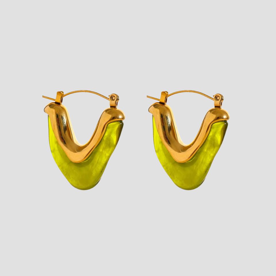 Flat lay of GRISÉ NYC olive resin V-shape 18k gold plated earrings