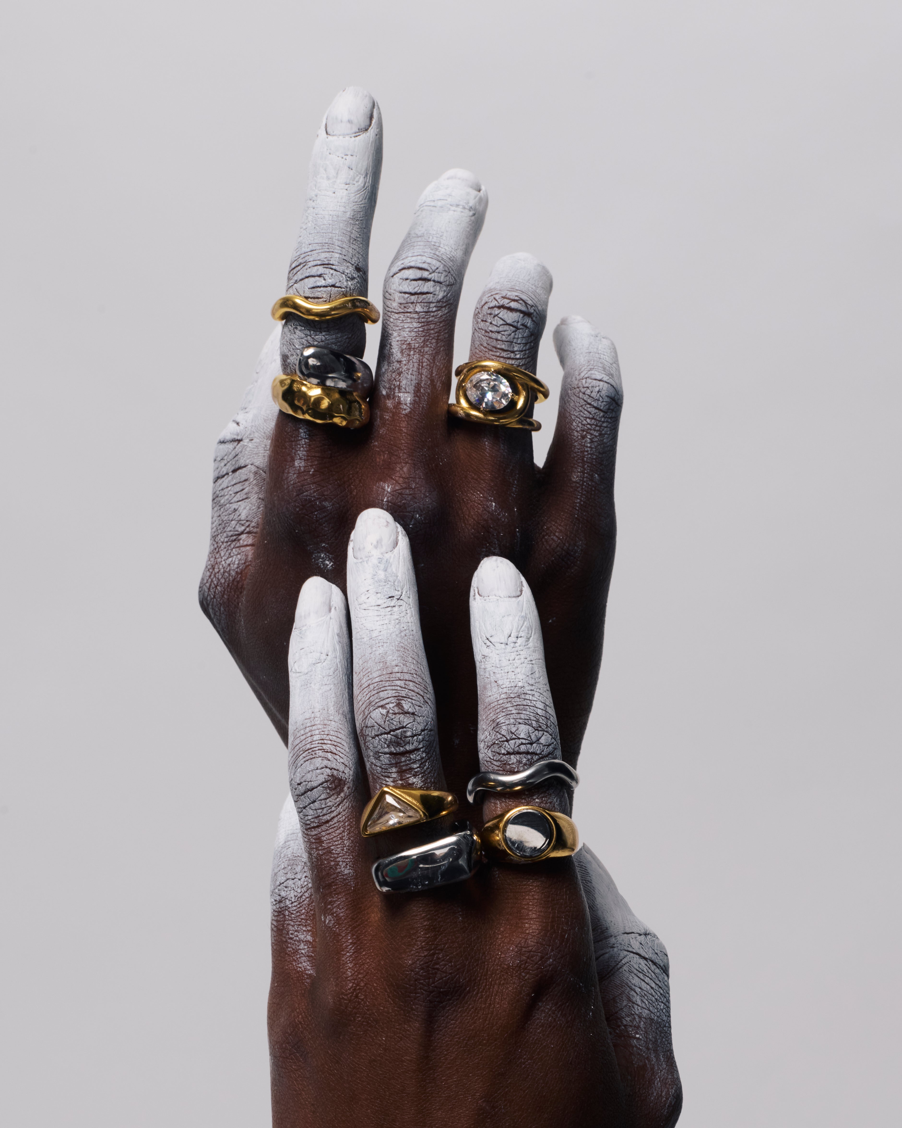 Close up of GRISÉ NYC oval gemstone gold ring with bold sculptural design and radiant crystal stone