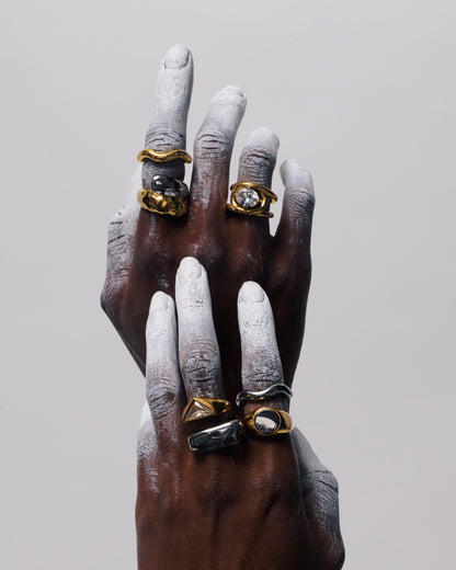Close up of GRISÉ NYC oval gemstone gold ring with bold sculptural design and radiant crystal stone