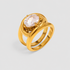 GRISÉ NYC gold statement ring with oversized oval crystal stone on light grey background