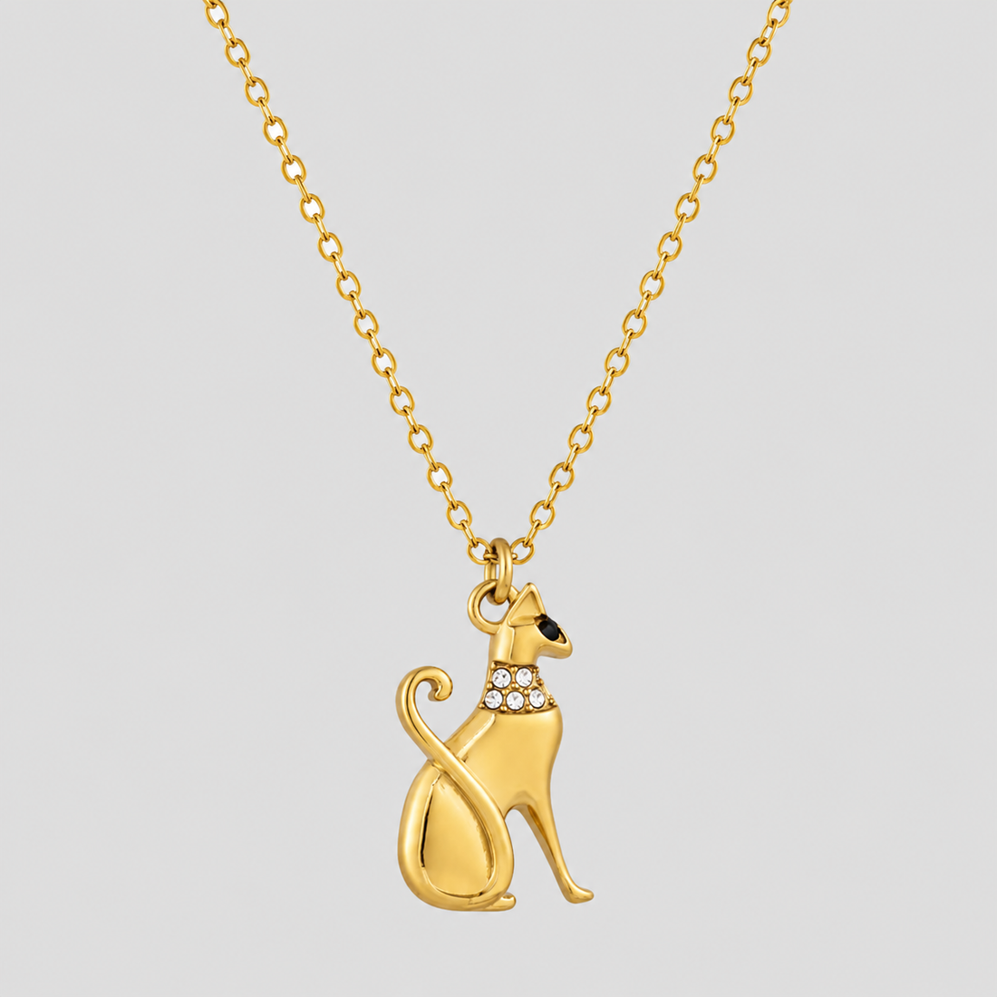 GRISÉ NYC Princess Kitty Necklace in 18k gold plated stainless steel with rhinestone collar detailing on a delicate gold chain against a light grey background