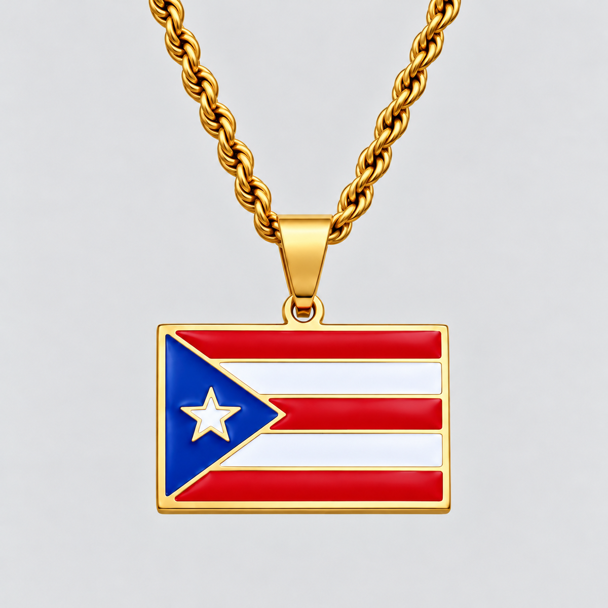 GRISÉ NYC gold Puerto Rican flag pendant necklace featuring vibrant red, white, and blue enamel detailing with a white star, paired with a 3mm gold rope chain on a light grey background.