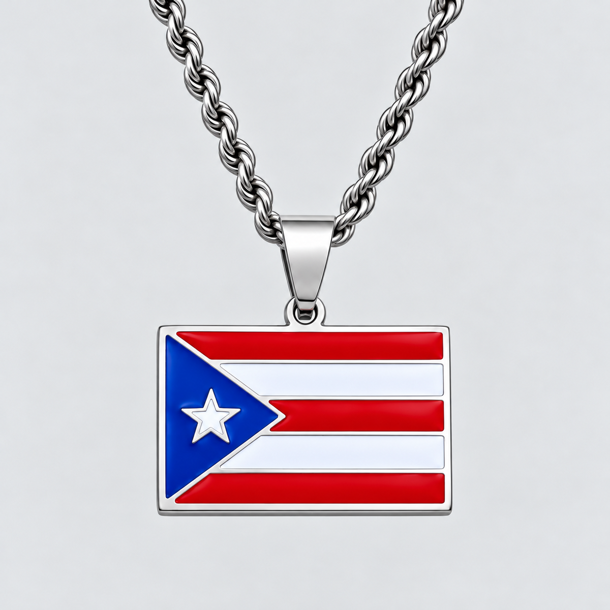 GRISÉ NYC silver Puerto Rican flag pendant necklace featuring vibrant red, white, and blue enamel detailing with a white star, paired with a 3mm silver rope chain on a light grey background.