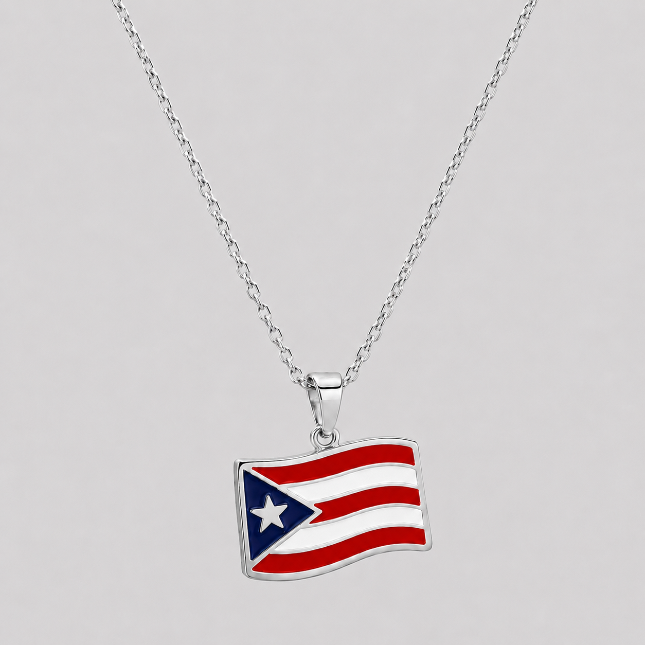 GRISÉ NYC Puerto Rico flag pendant necklace in stainless steel enamel with waving flag charm and silver-tone star detail.