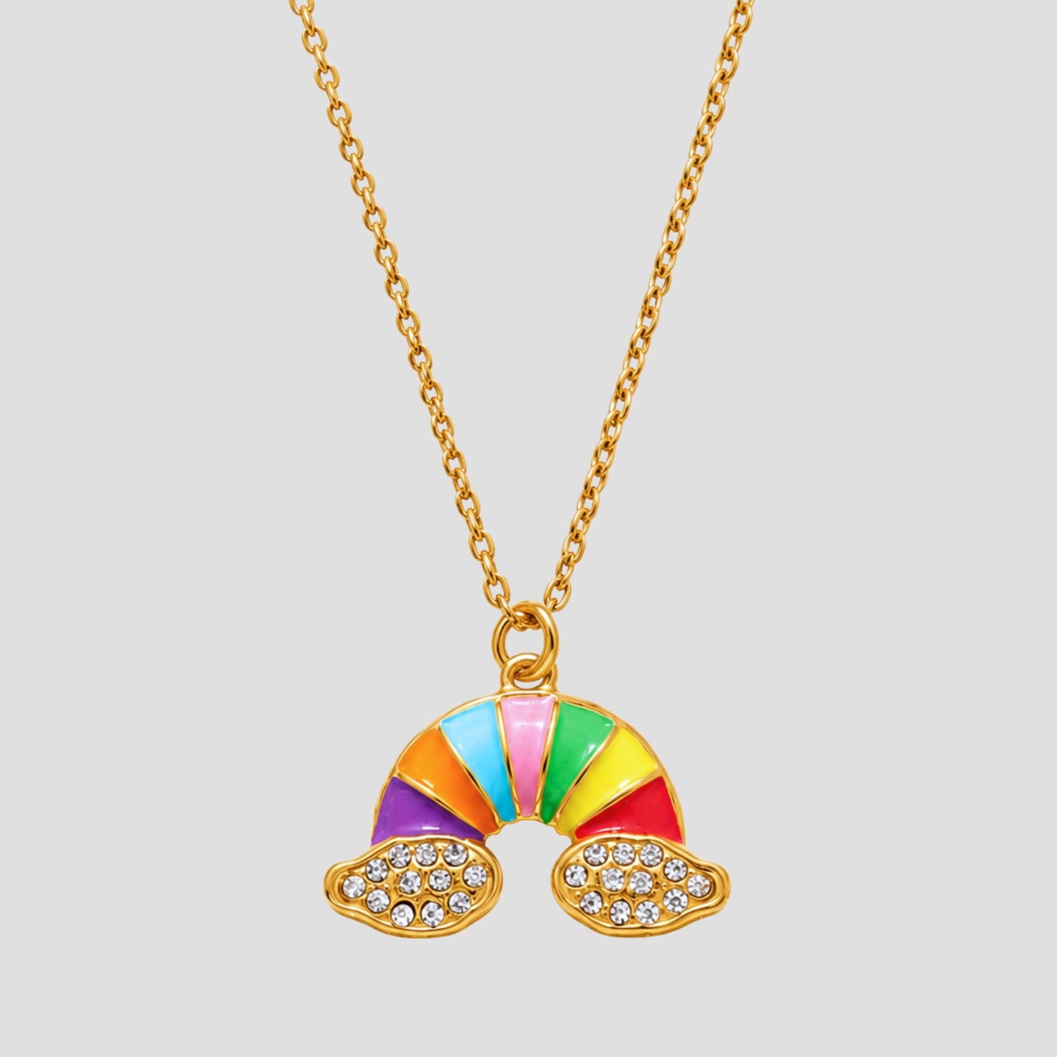 GRISÉ NYC Rainbow Cloud Pendant Necklace in 18K gold plated stainless steel with colorful enamel rainbow, pavé CZ cloud details, and waterproof tarnish-resistant finish.