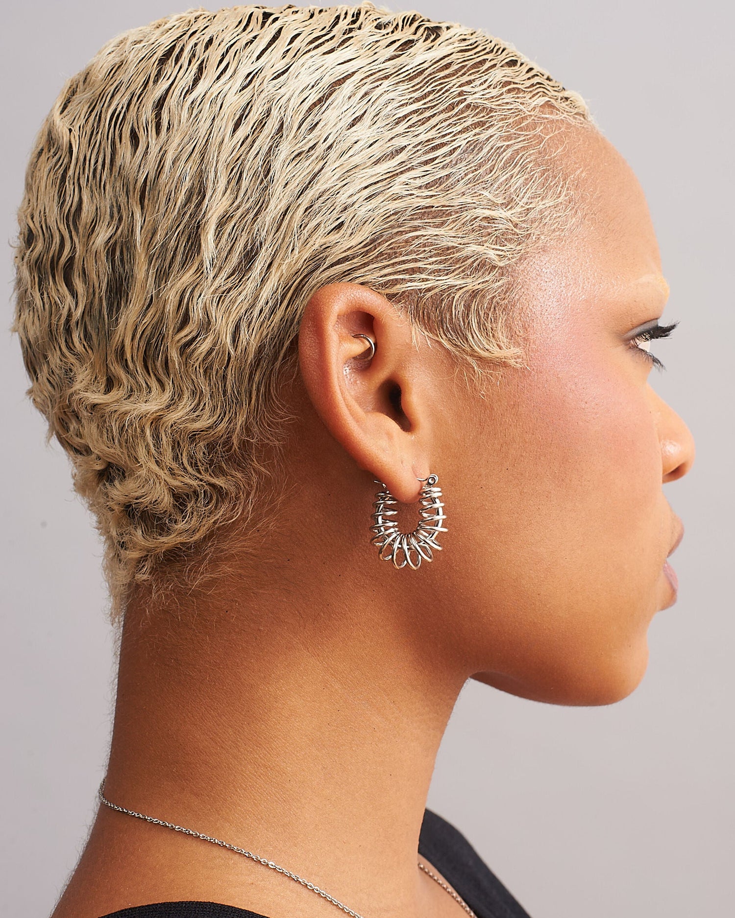 GRISÉ NYC silver barbed wire hoop earrings side angle showing sculptural wire detail