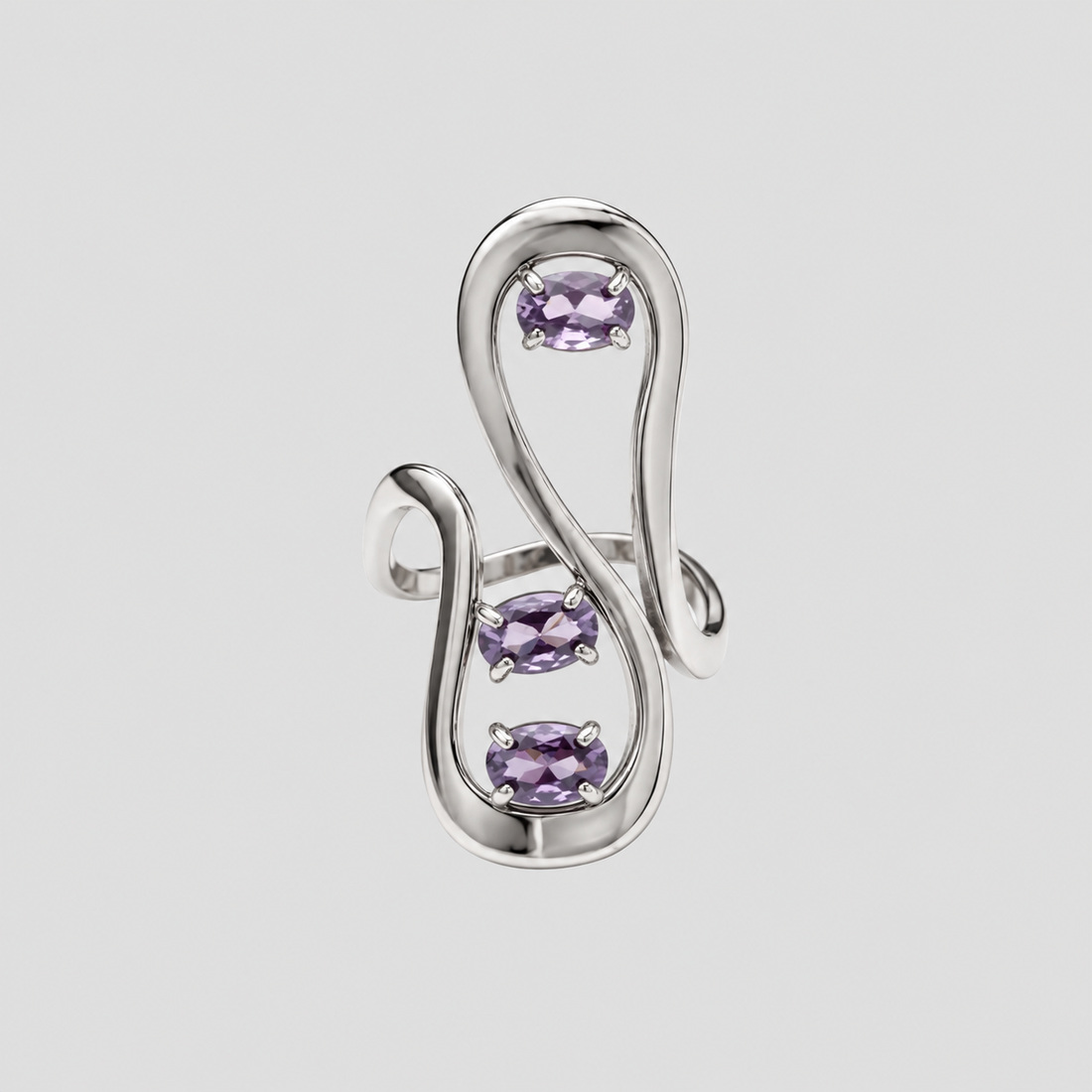 GRISÉ NYC silver sculptural statement ring featuring three oval lavender purple gemstones set within an abstract flowing openwork design against a light grey background.