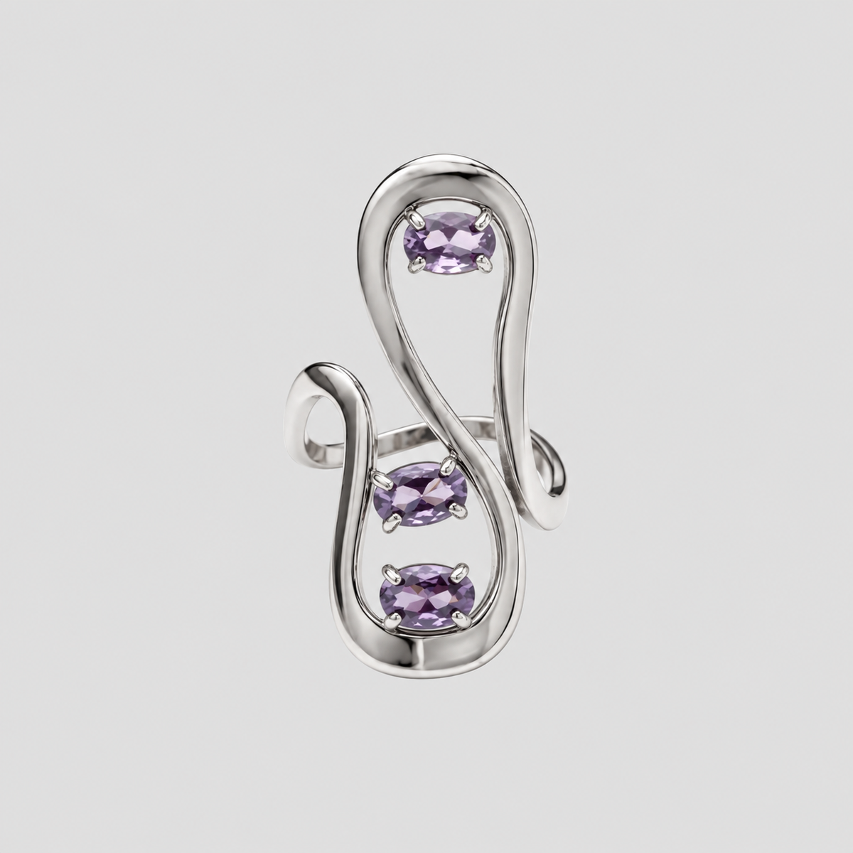 GRISÉ NYC silver sculptural statement ring featuring three oval lavender purple gemstones set within an abstract flowing openwork design against a light grey background.