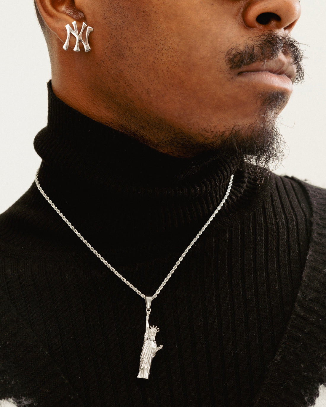 Male model wearing Statue of Liberty stainless steel necklace by GRISÉ NYC