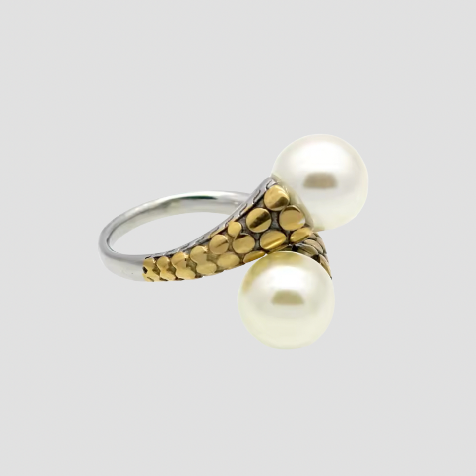 Flat lay of GRISÉ NYC two-tone pearl crossover ring.