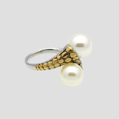 Flat lay of GRISÉ NYC two-tone pearl crossover ring.